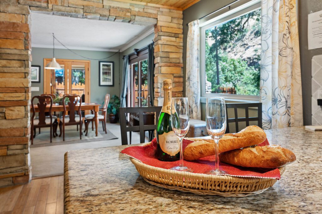 A basket of bread and wine on the counter.