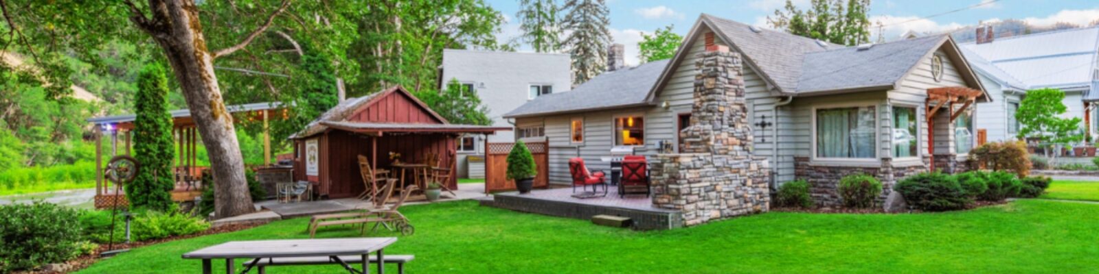 A backyard with a patio and a shed.