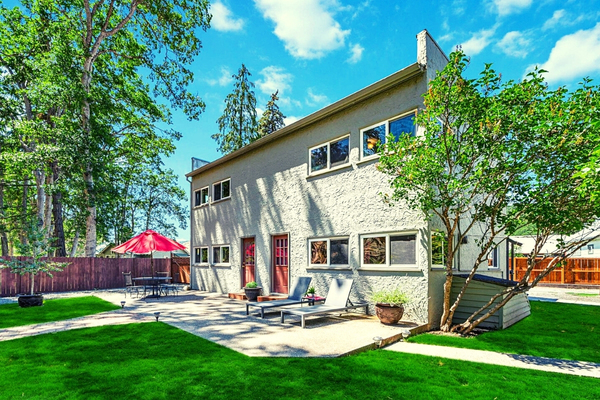 A large white building with two red doors.