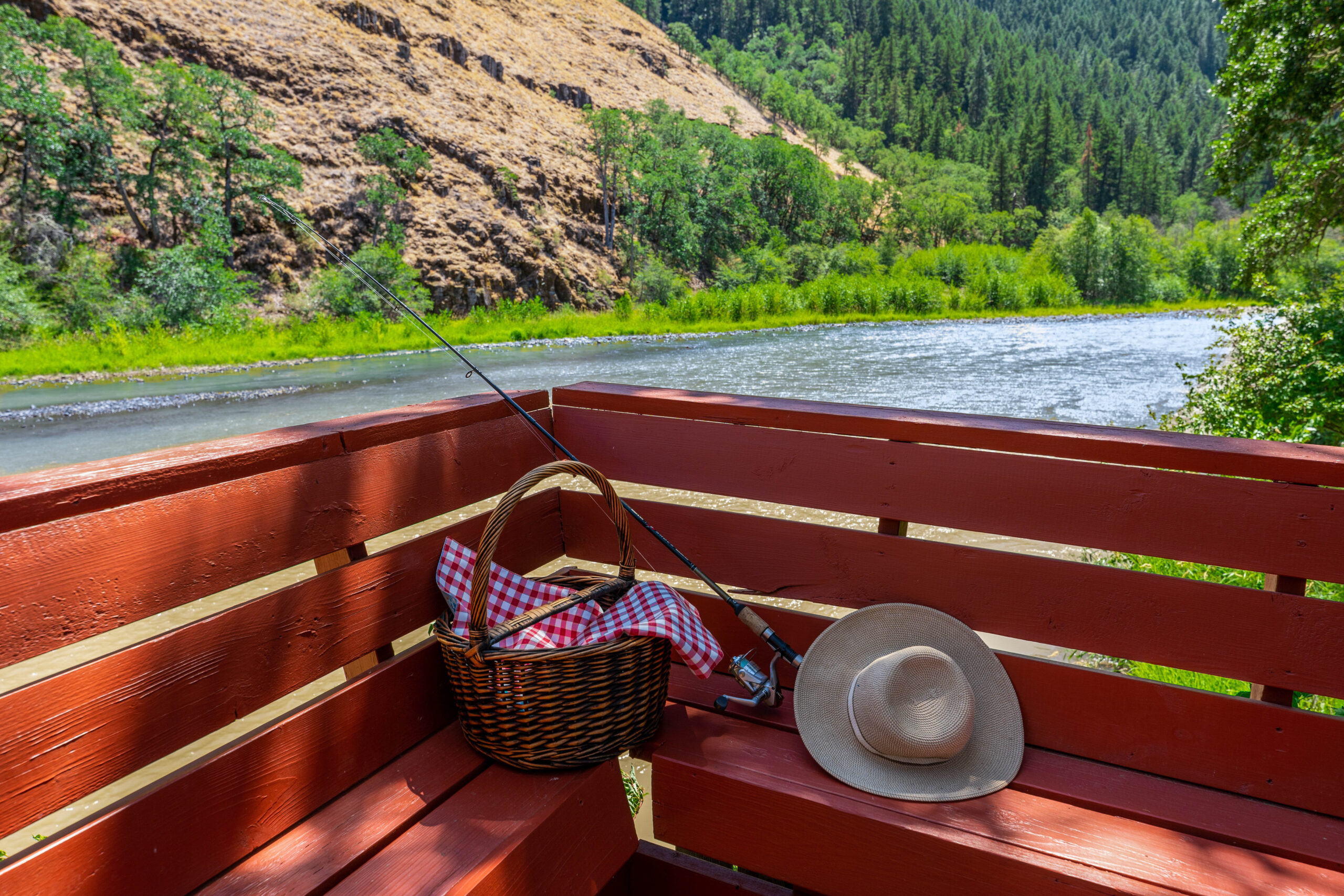 A basket and hat on the back of a boat.