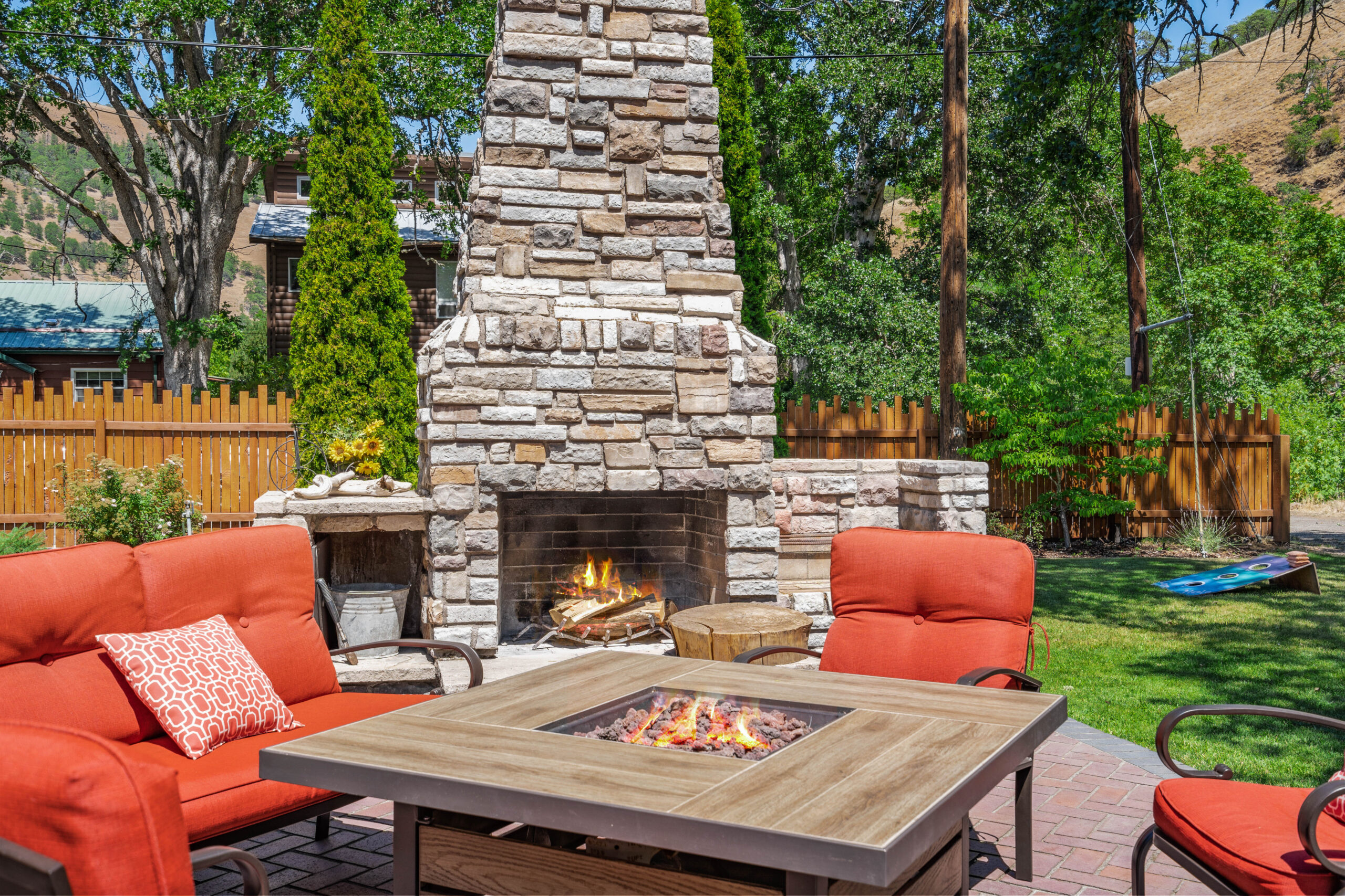 A fire pit sitting next to a stone fireplace.