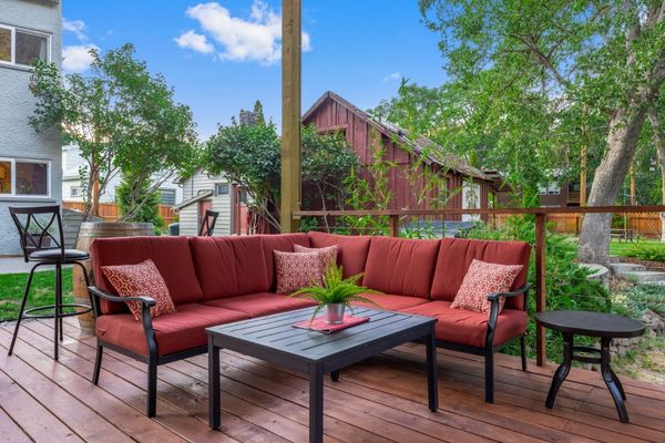 A patio with red furniture and a table