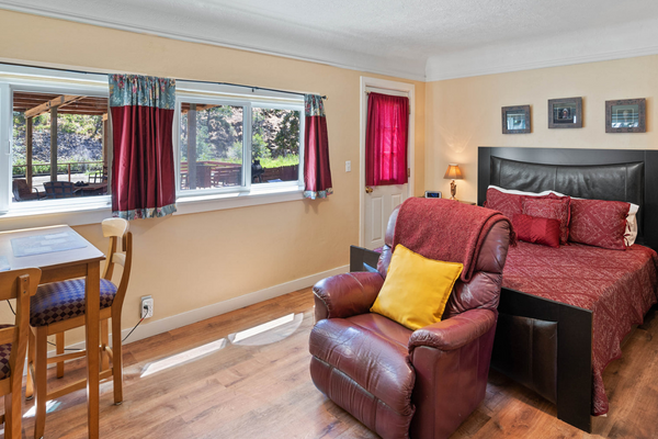 A living room with a bed and chair in it