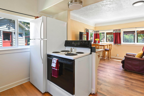 A kitchen with an oven and refrigerator in it