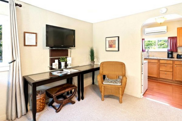 A living room with a tv and a desk