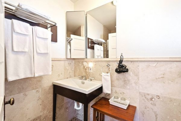 A bathroom with a sink and mirror in it