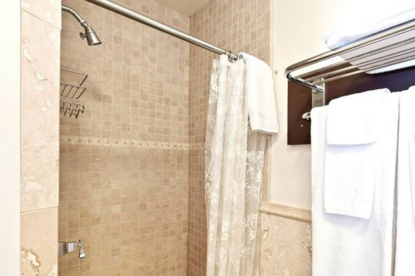 A bathroom with a shower and tiled walls.