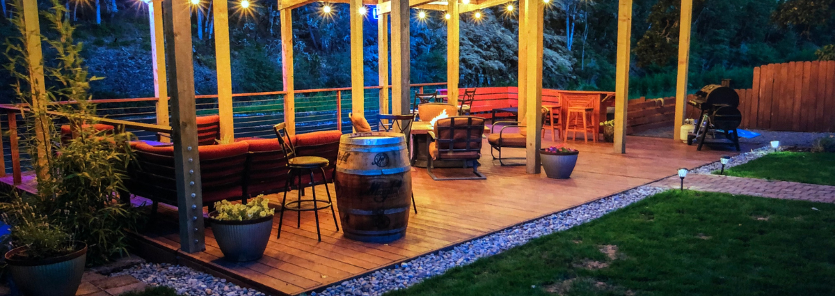 A patio with chairs and tables in the evening.