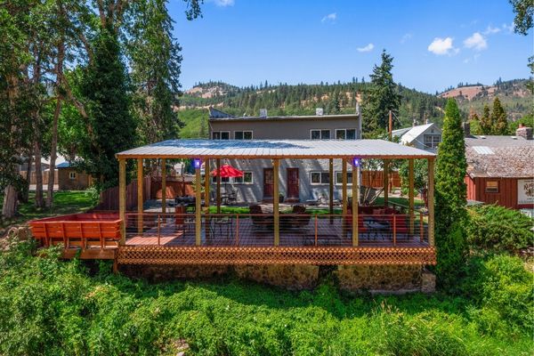 A deck with chairs and a roof over it