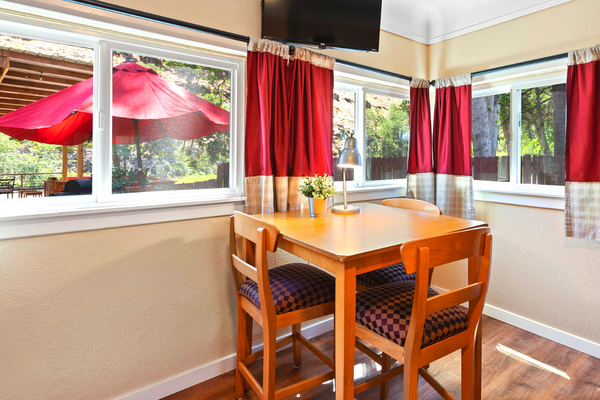 A table and chairs in front of a window.