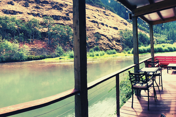 A river view from the deck of a cabin.