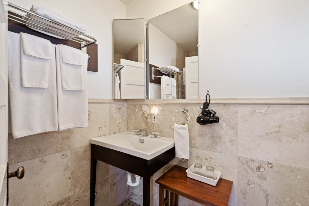 A bathroom with a sink and mirror in it