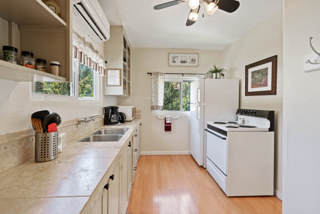 A kitchen with white cabinets and appliances in it